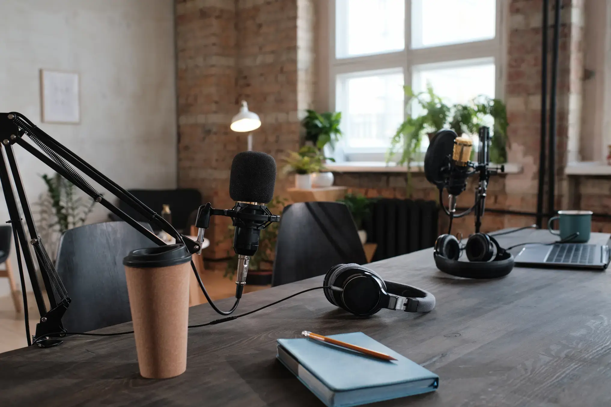 Podcast recording desk with microphones and headphones